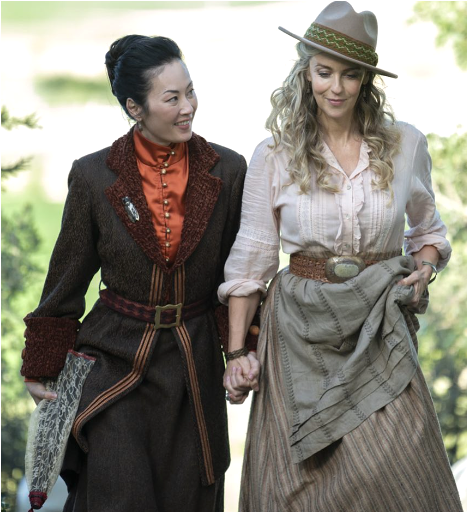 Olivia Cheng in historical dress holding hands